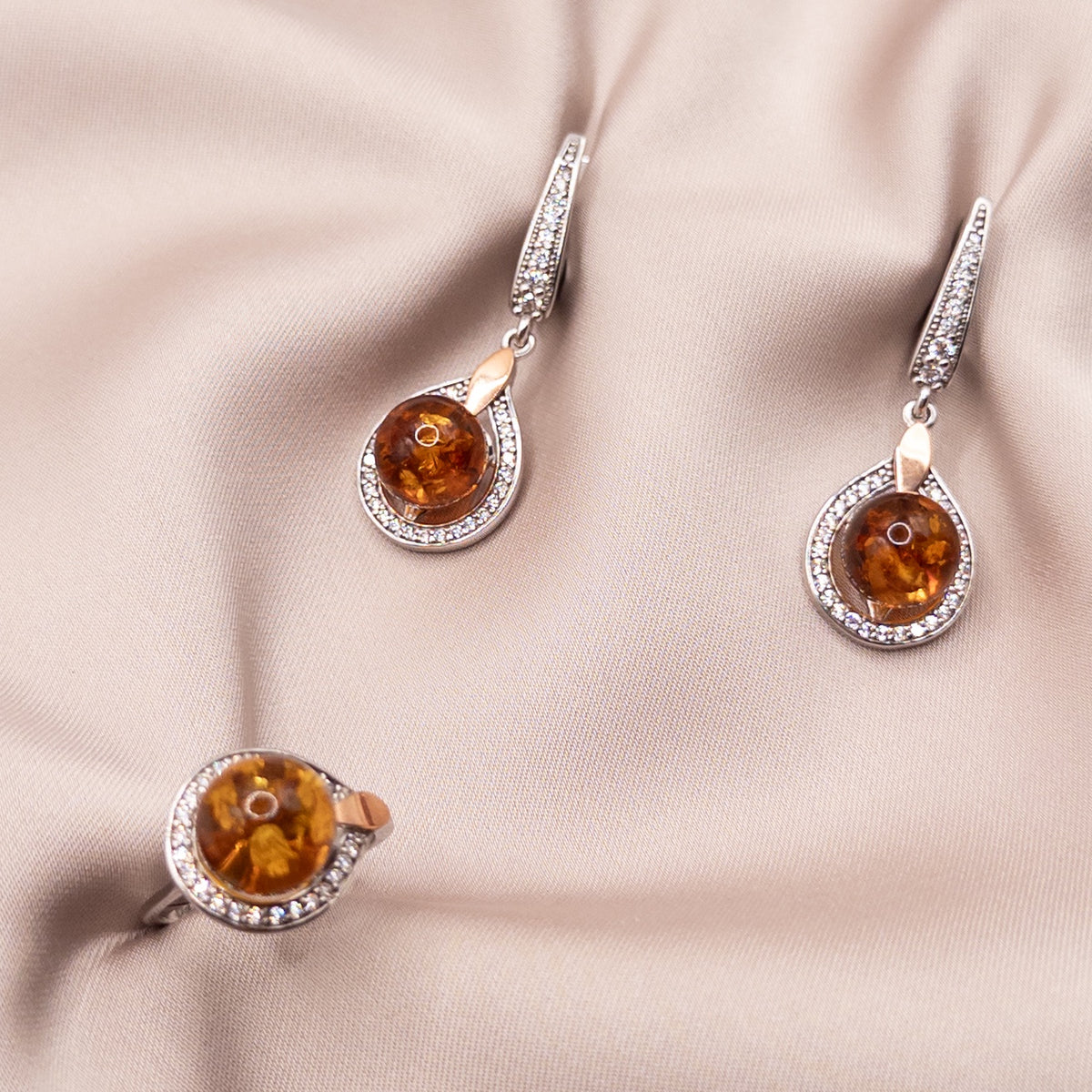 Silver set with gold inserts with zircon and amber