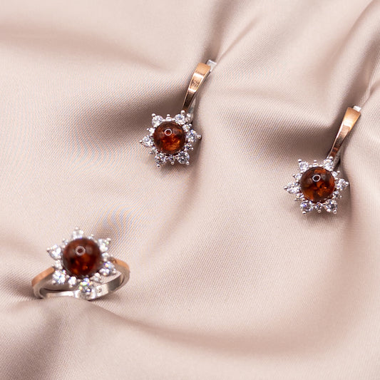 Silver set with gold accents, zircon, and amber
