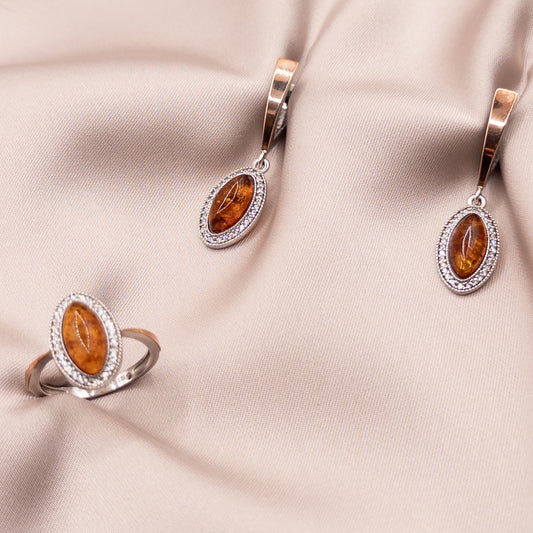 Silver set with gold inserts, cubic zirconia, and amber